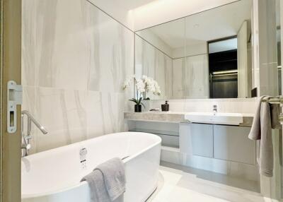 Modern bathroom with bathtub and large mirror