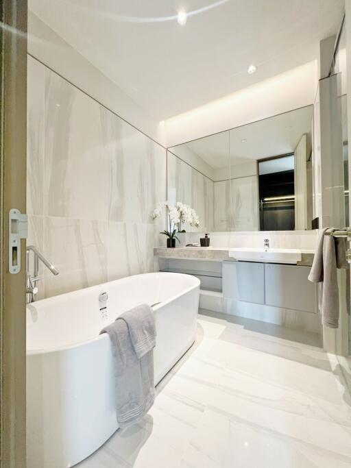 Modern bathroom with bathtub and large mirror