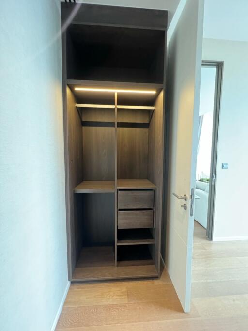 Walk-in closet with open shelves and drawers