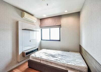 simple bedroom with mattress and air conditioner