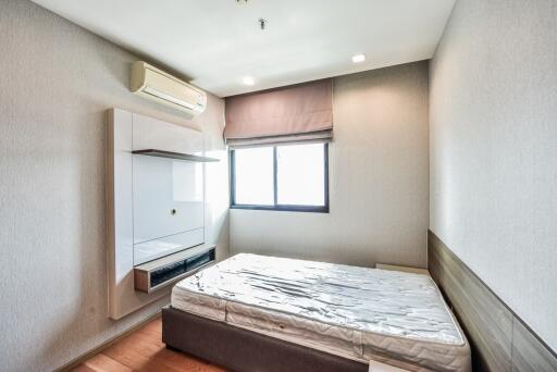 simple bedroom with mattress and air conditioner