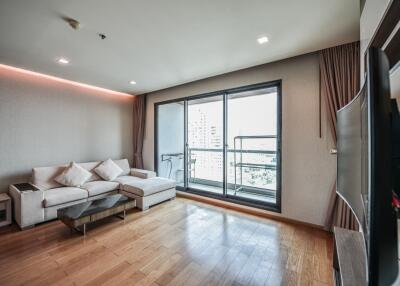 Modern living room with hardwood floors and balcony