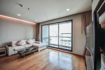 Modern living room with hardwood floors and balcony