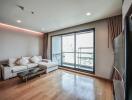 Modern living room with hardwood floors and balcony