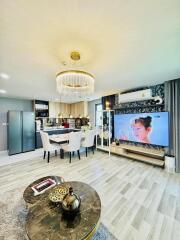 Modern living space with dining area, TV, and kitchen