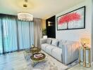 Contemporary living room with large gray sofa, chandelier, and modern decor