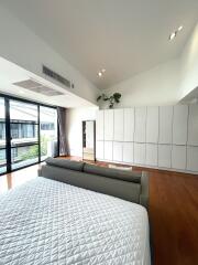 Spacious bedroom with large windows and ample storage