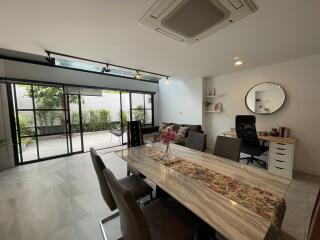 Modern living area with dining table and home office space