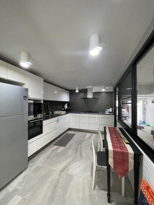 Modern kitchen with white cabinets and stainless steel appliances