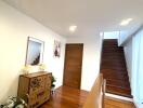 Well-Lit Hallway with Wooden Staircase