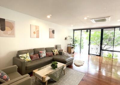 Spacious modern living room with large windows and comfortable seating