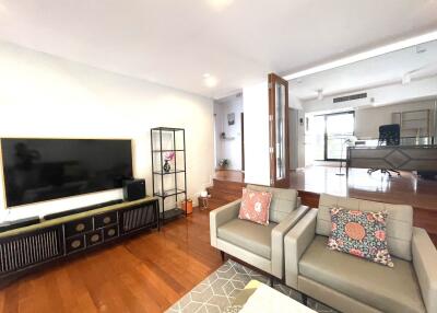 Spacious living room with TV and shelving units