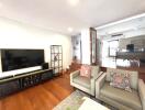 Spacious living room with TV and shelving units