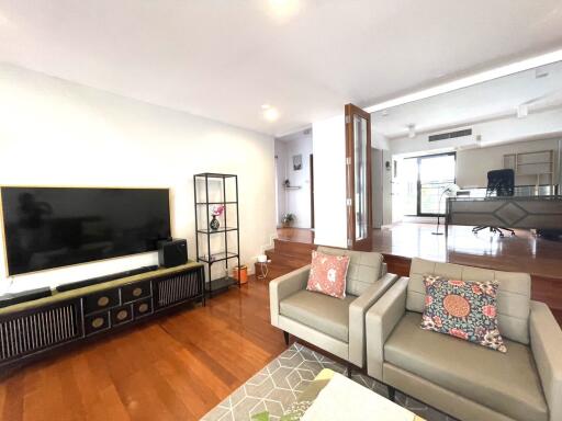 Spacious living room with TV and shelving units