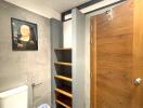 Bathroom with wooden door and wall shelves