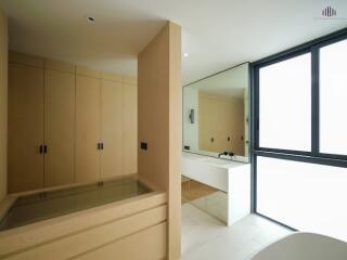 Modern bathroom with wooden cabinets and large mirror