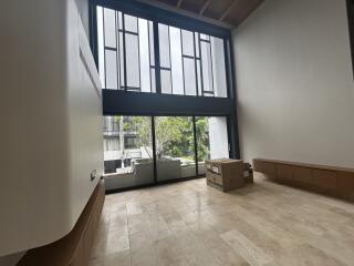 Spacious living room with large windows and natural light