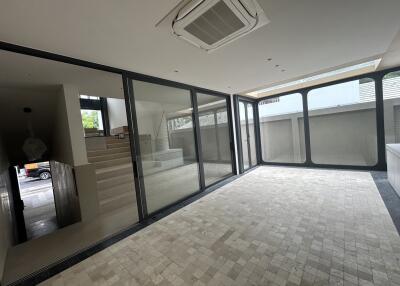 Modern open area with large windows and tiled flooring