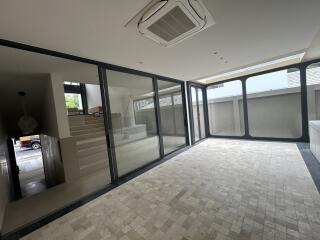 Modern open area with large windows and tiled flooring