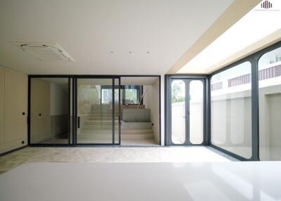 Spacious living area with large glass doors and stairway