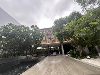 Modern building with wooden deck and lush greenery