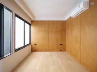 Modern minimalistic bedroom with wooden panel walls and large windows