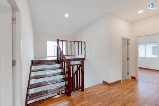 Staircase area with wooden steps and handrails