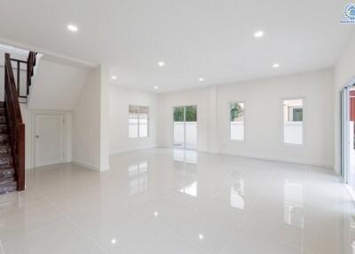 Spacious main living area with large windows and staircase