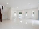 Spacious main living area with large windows and staircase