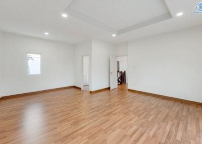 Spacious living room with wood flooring and recessed lighting