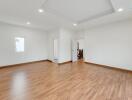 Spacious living room with wood flooring and recessed lighting