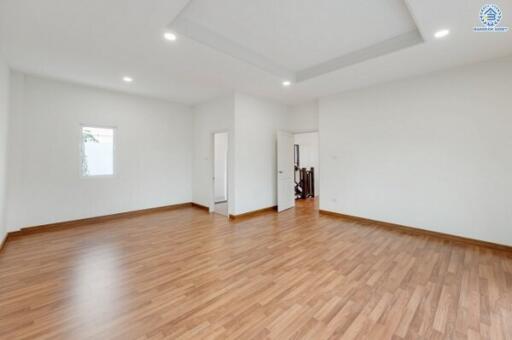 Spacious living room with wood flooring and recessed lighting