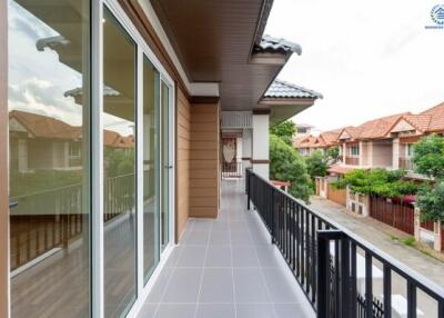 Spacious balcony with sliding glass doors and view of the neighborhood