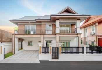 Modern two-story house with driveway and gated entrance