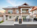 Modern two-story house with driveway and gated entrance