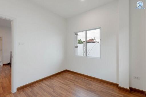 Small bedroom with window and wooden floor