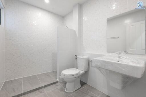 Modern white bathroom with large mirror and walk-in shower