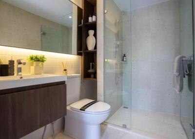 Modern bathroom with glass shower and wooden vanity