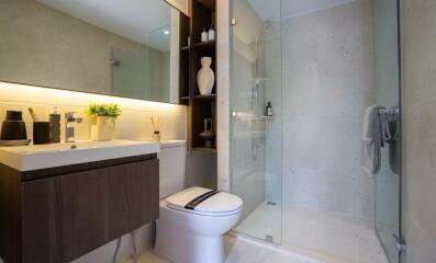 Modern bathroom with glass shower and wooden vanity