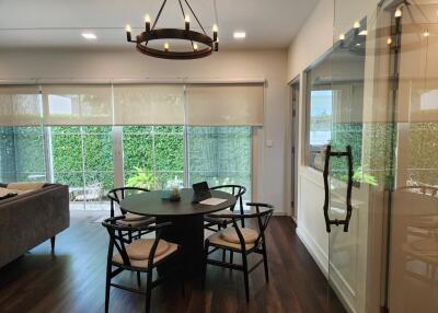 Modern open dining and living area with large windows