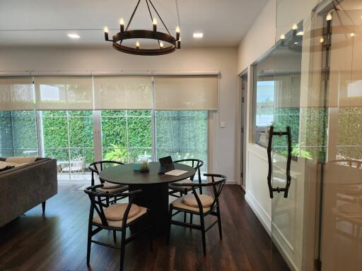 Modern open dining and living area with large windows