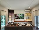 Modern living room with brown sofa, mounted TV, and large windows