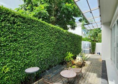 Outdoor patio area with greenery