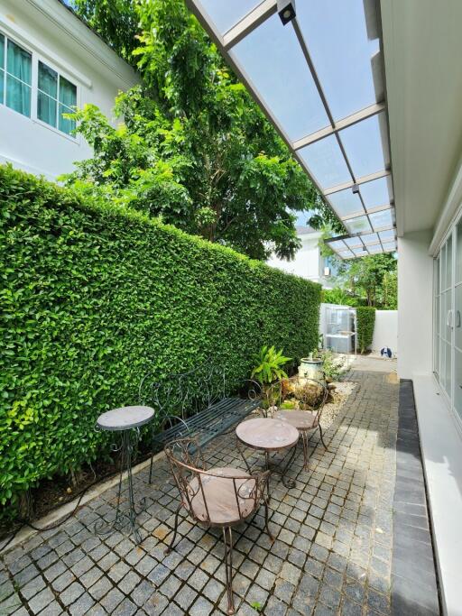 Outdoor patio area with greenery