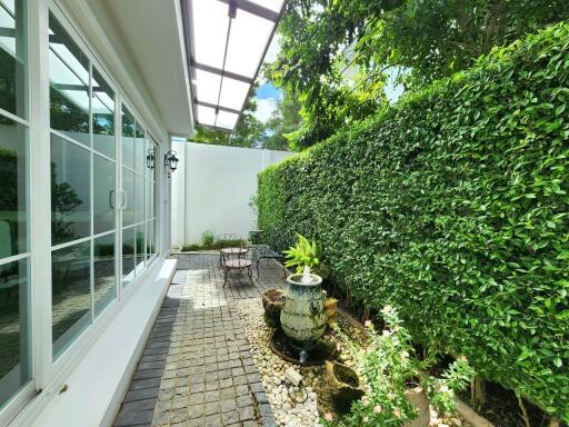 Outdoor garden with seating area and water fountain