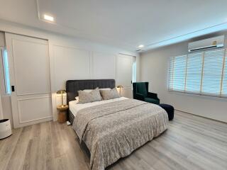 Spacious modern bedroom with a large bed and stylish furnishings