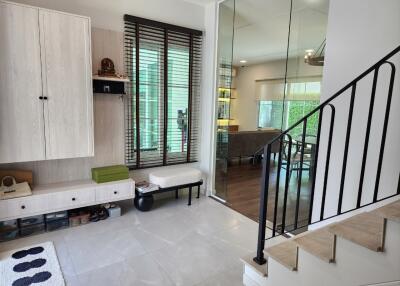 Modern living area with staircase and large windows