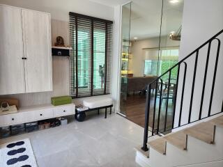 Modern living area with staircase and large windows