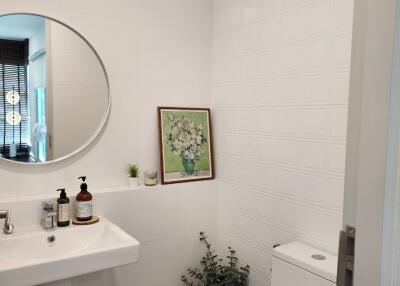 Modern bathroom view with sink, mirror, and toilet