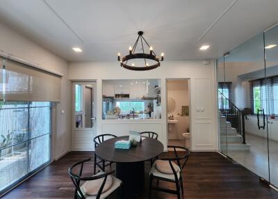 Contemporary dining area with round table and modern chandelier